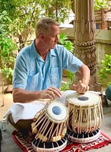 Matthew Nelson playing Tabla at a temple in India