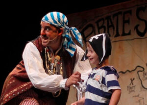 Pirate actor with child on stage